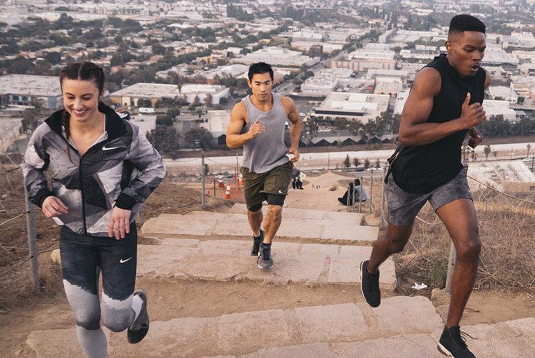Group Running Up Steps In City