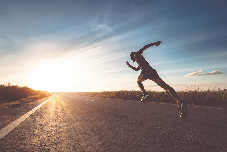 Man Sprinting Down Road