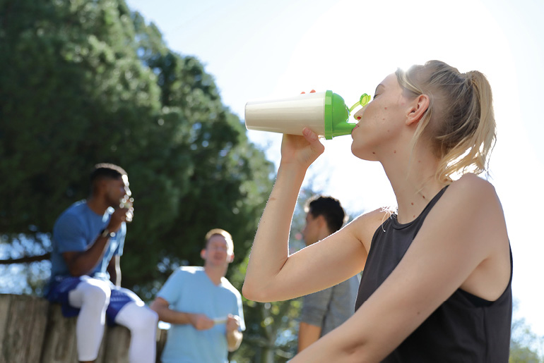 Woman Drinking Shake In Group
