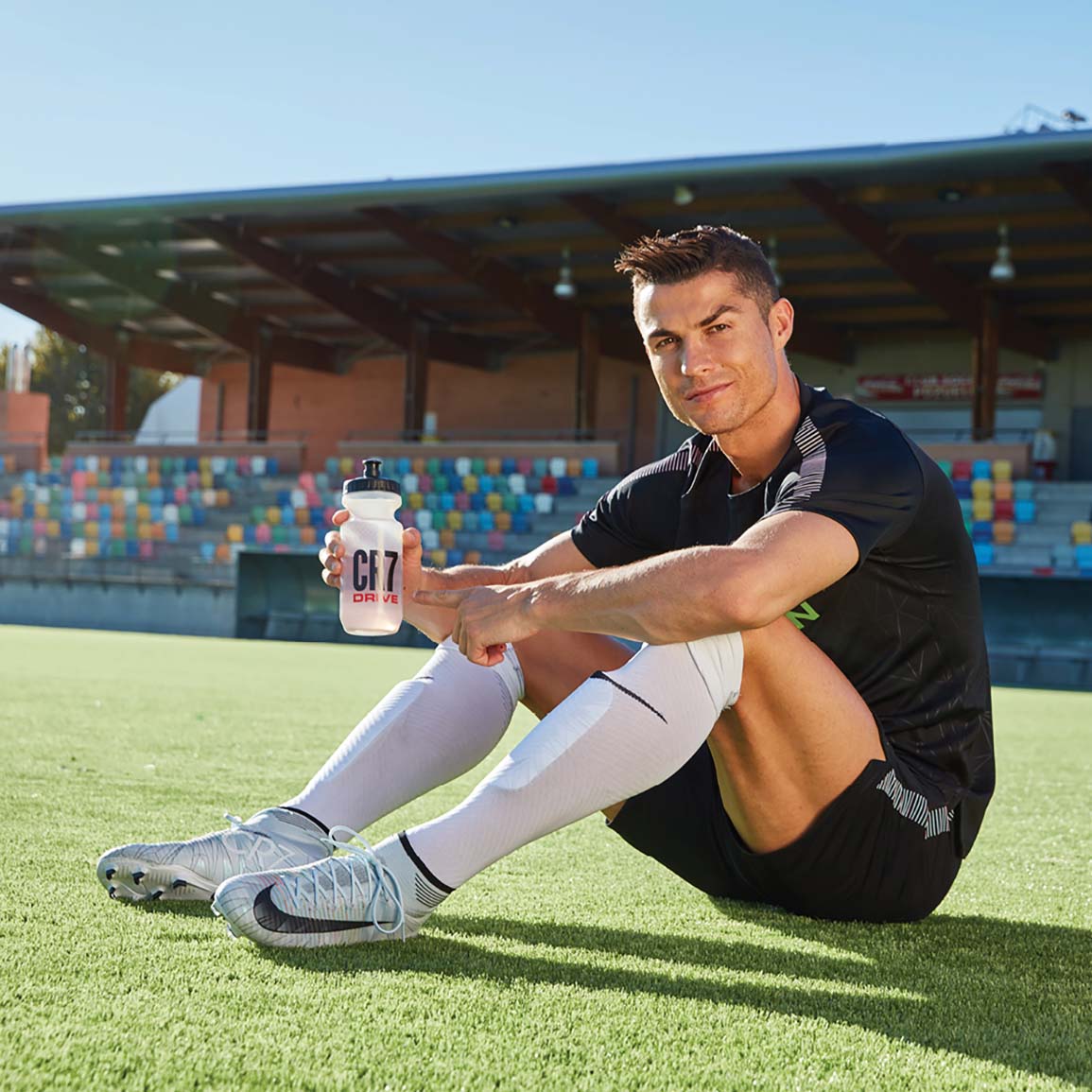 Cristiano Ronaldo Sat On The Pitch In A Stadium With Cr7 Drive