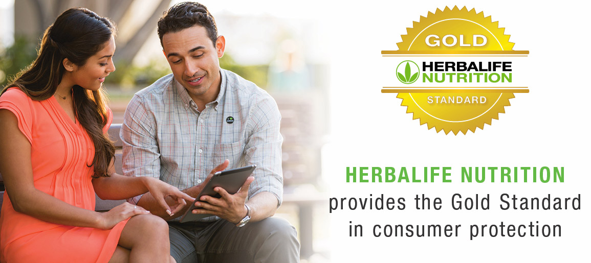Herbalife Nutrition Members Looking At An Ipad Signifying The Gold Standard Guarentee In Consumer Protection