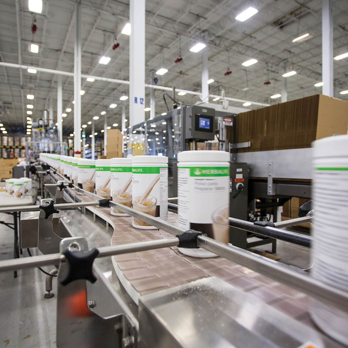 Herbalife Nutrition Products On A Conveyor Belt In The Warehouse