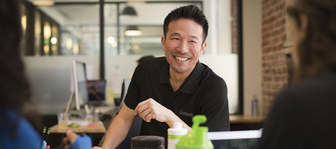 Man Talking To Two Customers With Shakes And Products On The Table