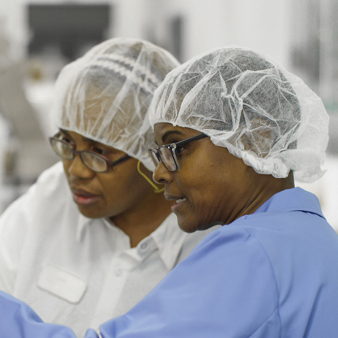 Scientist Teaching Another Scientist In The Warehouse