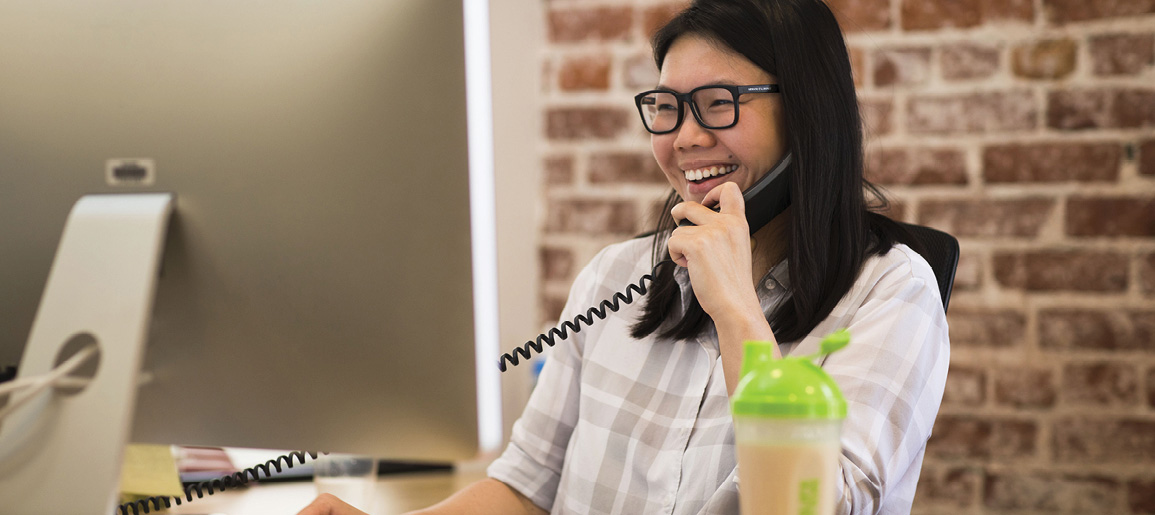 Woman On Phone Looking At Laptop With Shake