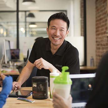 Man Talking To Two Customers