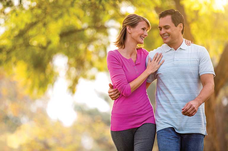 Couple Walking In Park