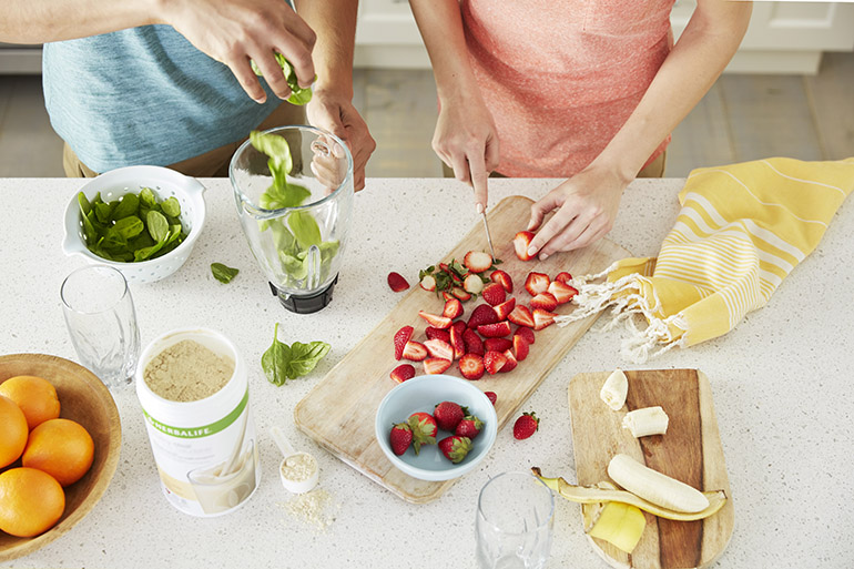 Global Lifestyle Shoot - Woman Cutting Strawberries