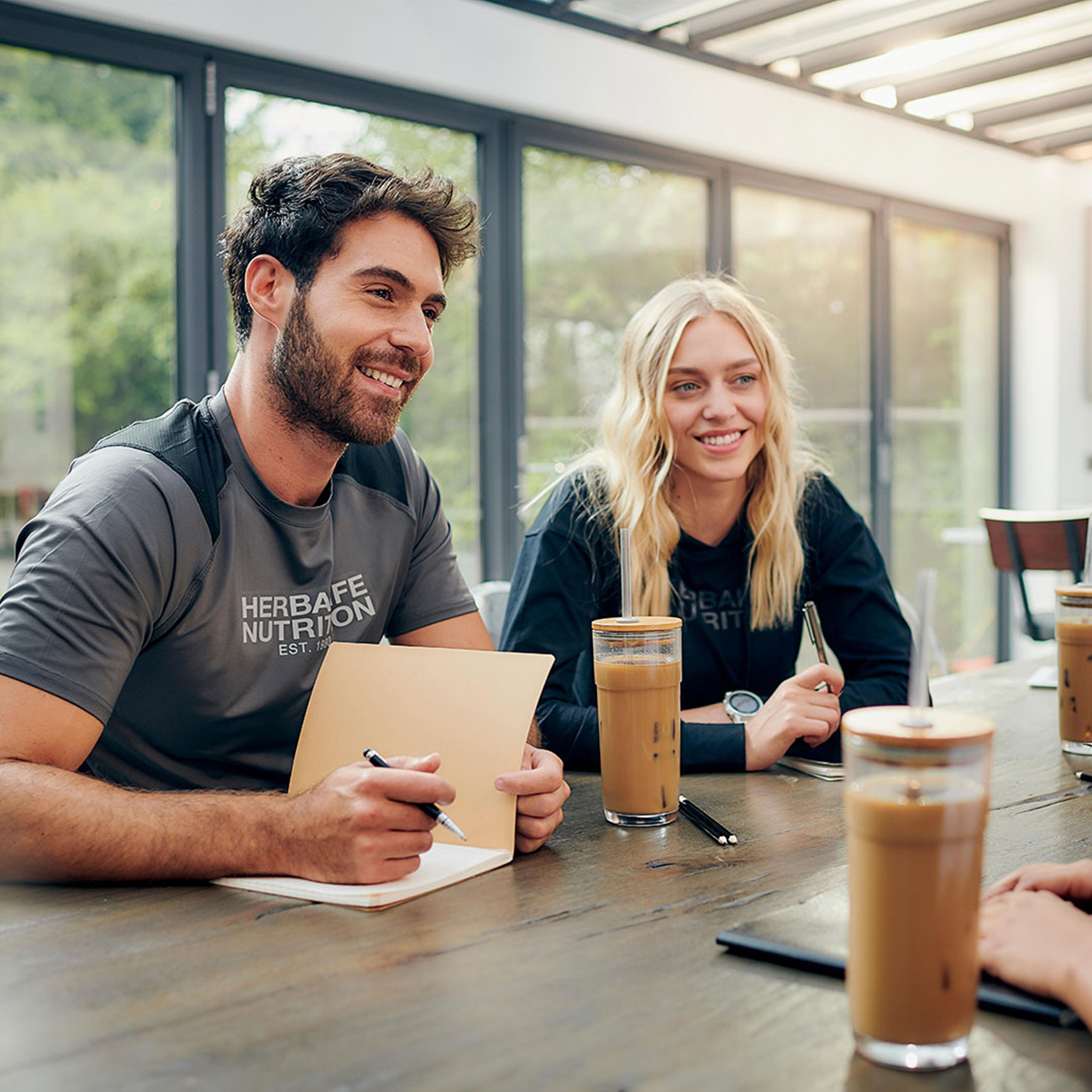 herbalife nutrition members talking and taking notes in a nutrition club